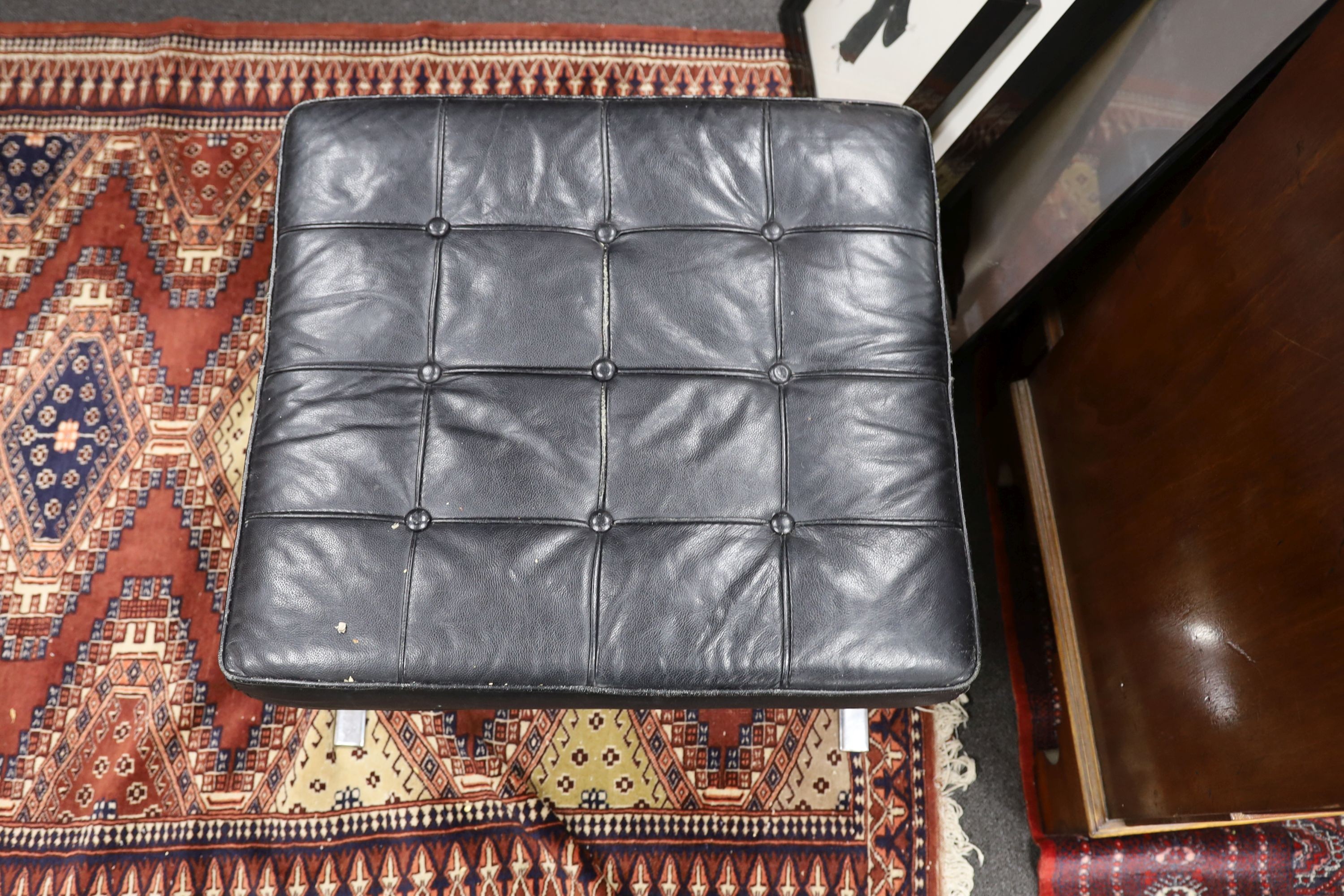 A Barcelona style black leather and chrome footstool, length 64cm, depth 57cm, height 37cm